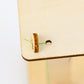 Wooden corner joint with brown wooden dowel and green thread line