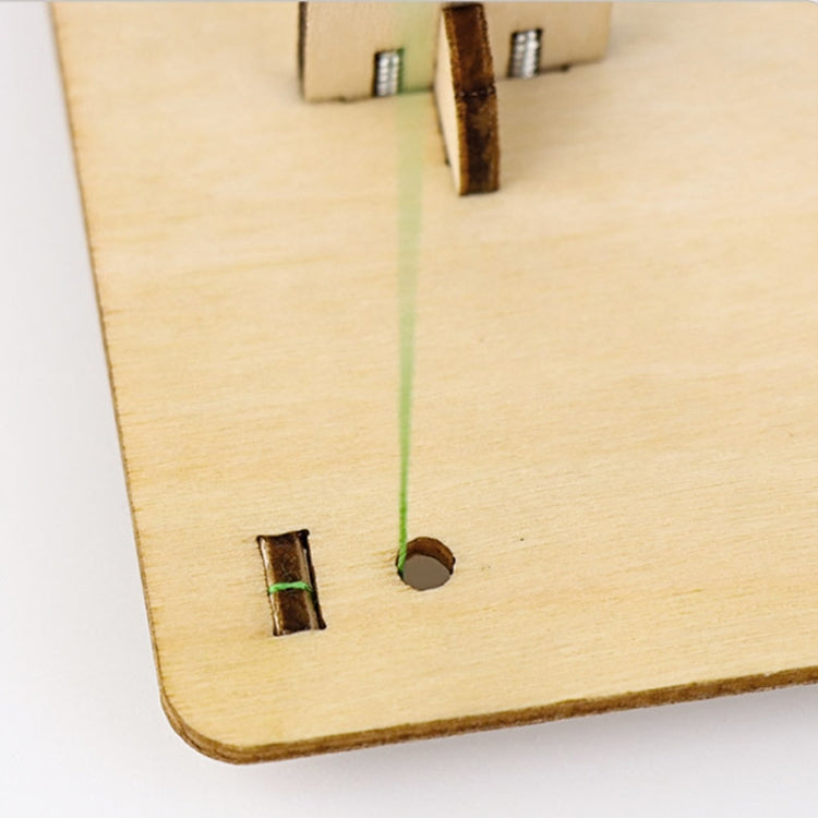Wooden base plate with two peg holes and green string thread across