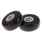 Close-up of two black luggage spinner replacement wheels with visible metal bearings