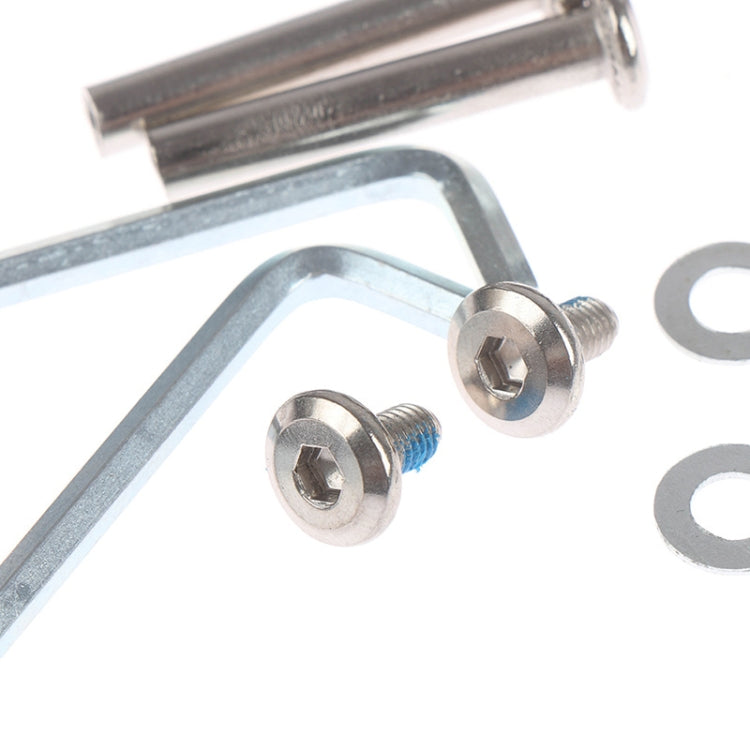 Close-up of metal luggage wheel mounting bracket and screws with washer pieces
