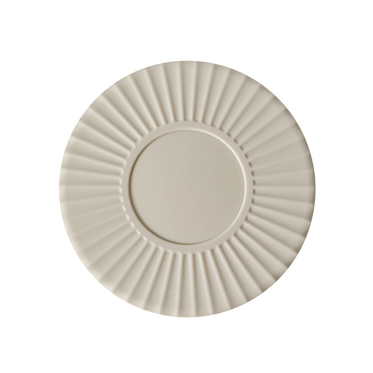 White silicone heat insulation mat with round ridged design and center insert.