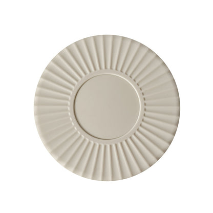 White silicone heat insulation mat with round ridged design and center insert.