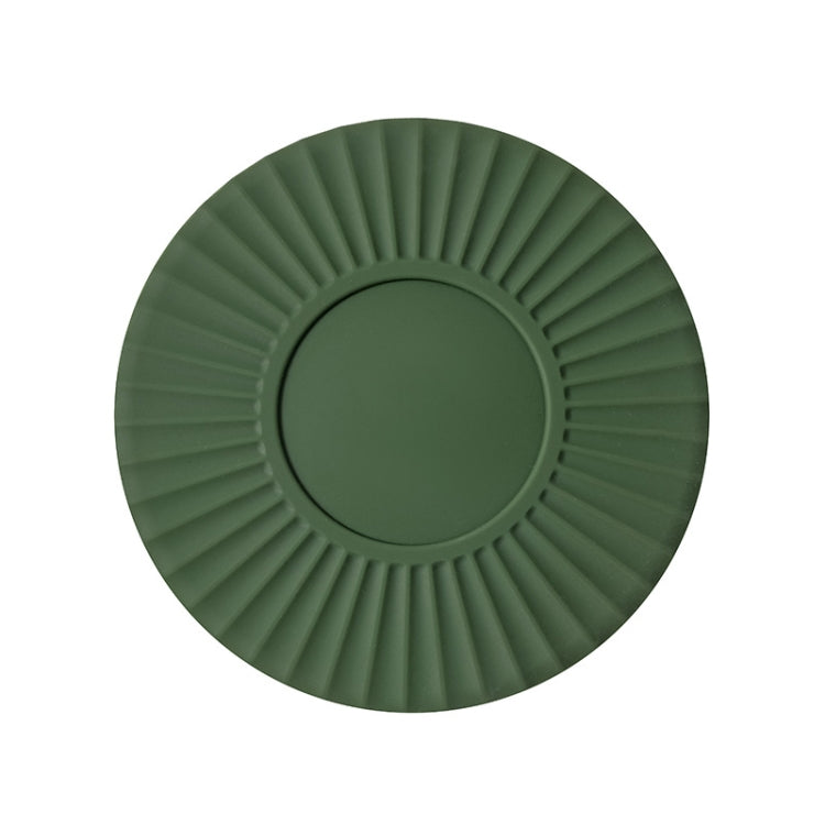 Green silicone heat insulation mat with round ridges and a flat circular center.