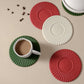 Assorted silicone heat insulation mats in red, green, and white with ridged centers.