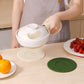 White silicone heat insulation mat on a table beneath a covered pot.