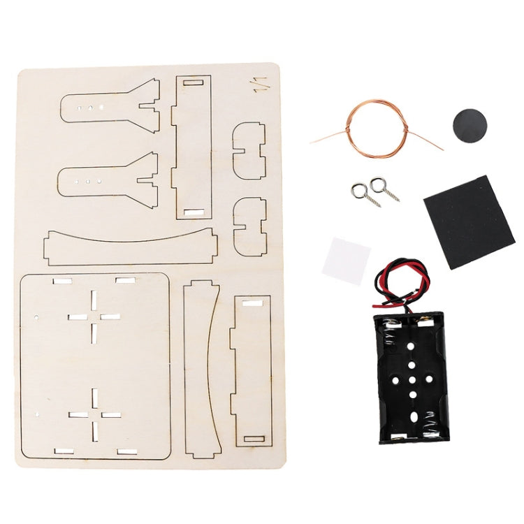 DIY DC motor kit parts: wooden board, copper wire ring, wires, and battery holder