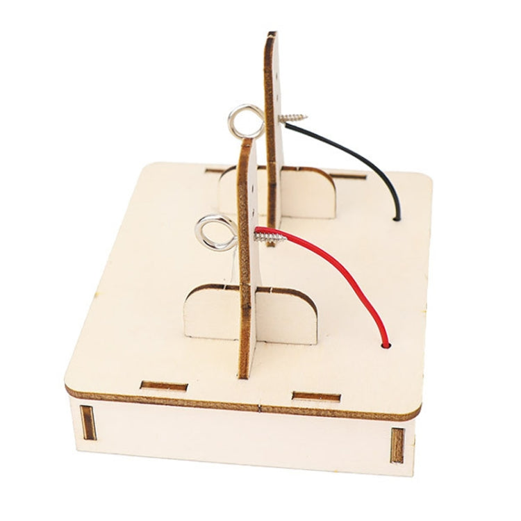 DIY DC motor kit wooden base with upright metal post and red/black wiring