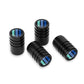 Four black knurled car tire valve caps with iridescent blue striped center
