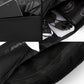 Black crossbody chest bag with open compartment holding small devices and accessories