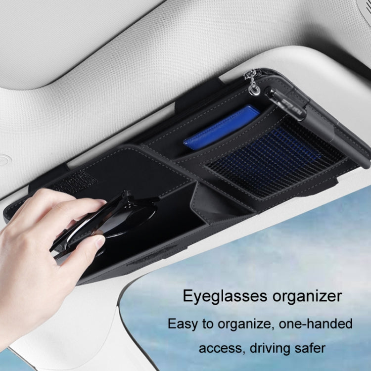 Black car sun visor organizer pouch with open storage compartments and mesh pocket