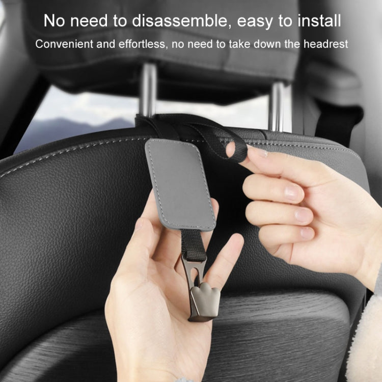 Grey seatback hook organizer installation with hand attaching clip to seat