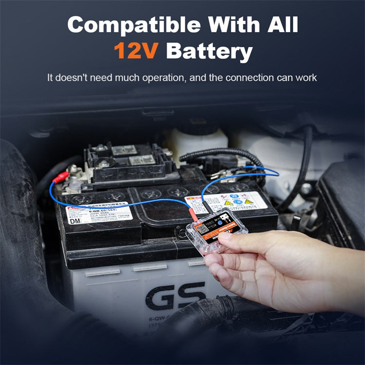 12V battery monitor tester connected to a car battery with hand holding the module