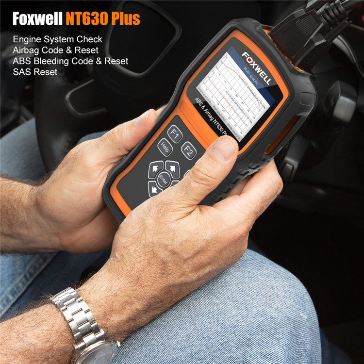 Hand using FOXWELL NT630 Plus OBD2 scanner plugged into vehicle dashboard