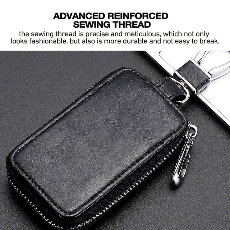 Black key fob case with reinforced stitching, transparent window, and metal key ring