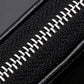 Black zippered key case with close-up of metal zipper teeth