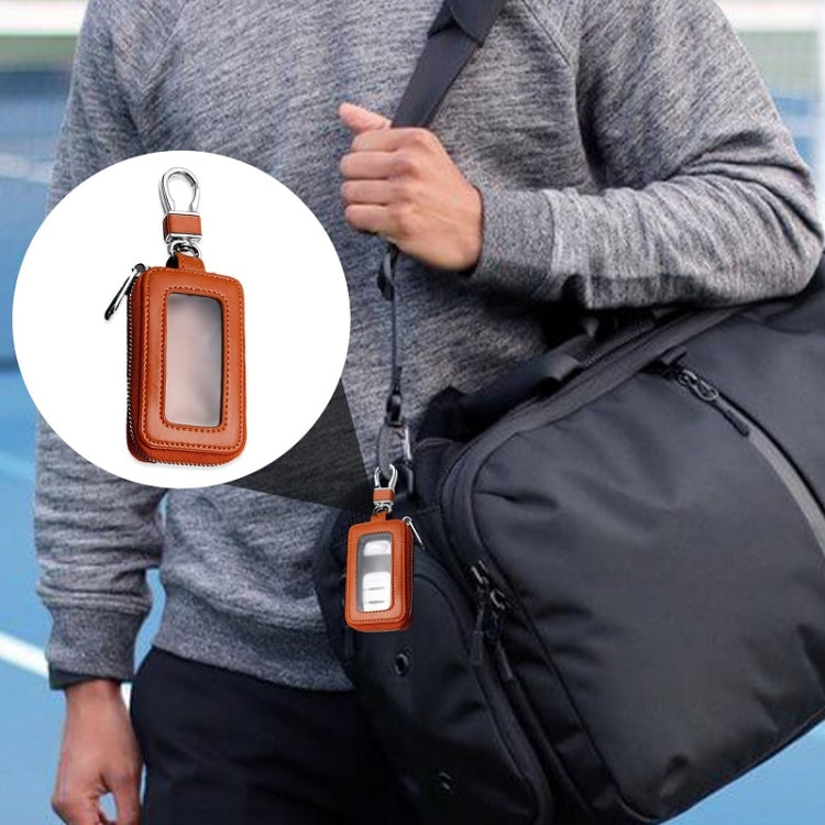 Car key fob zipper key case with clear window, hanging on a keychain strap, brown