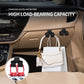 Black car armrest storage hooks holding two hanging handbags
