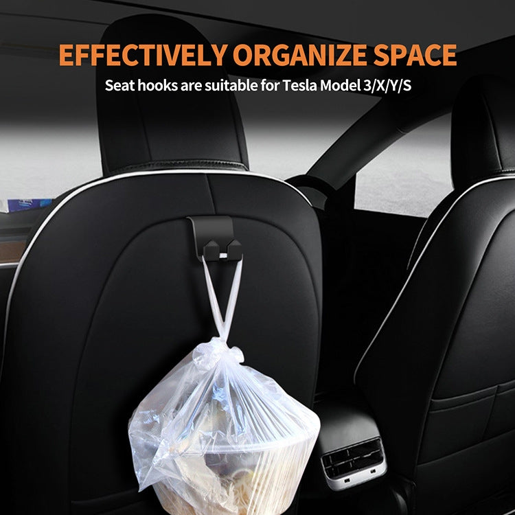 Tesla Model 3/Y rear seat headrest hook holding a clear bag on the back seat.