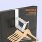 White door back coat hook holding a wooden hanger with multiple items underneath