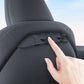 Multi-hook seat back bracket on dark car seat, hand pointing at hooks