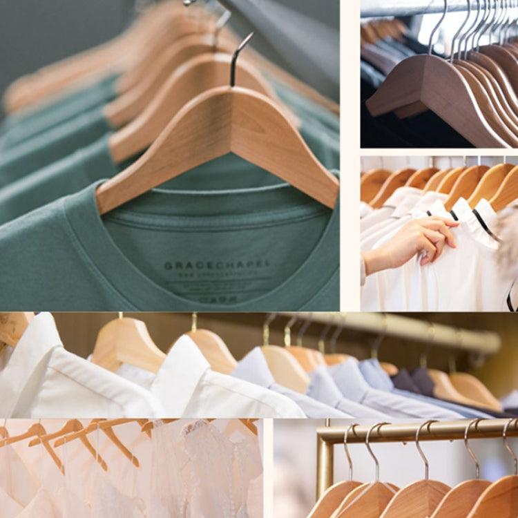Wooden clothes hangers on rack holding neatly arranged shirts.