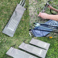 Gray drawstring ground spike storage bag with white graphic on grass