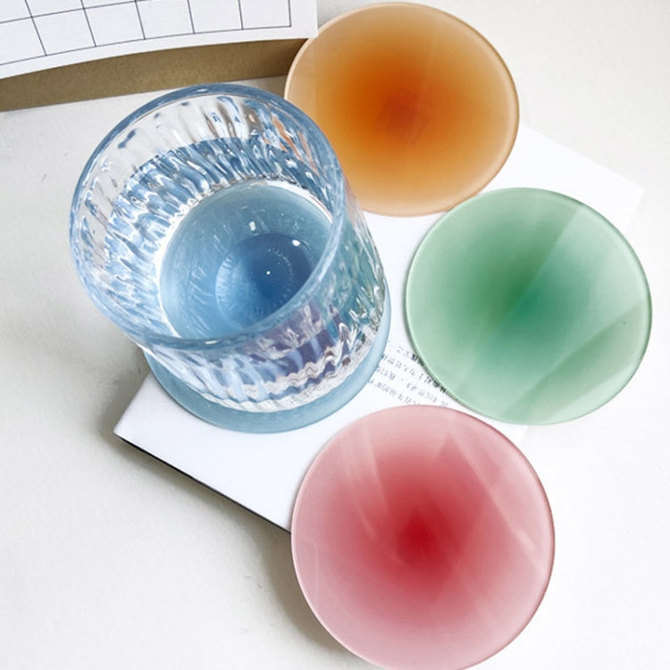 Assorted round translucent gradient coaster pads in blue, orange, green, and pink.