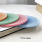 Stacked round translucent gradient coaster pads with thick edges in blue, pink, green.