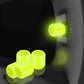 Yellow luminous car tire valve caps set, glowing at the wheel valve stem