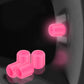 Pink luminous car tire valve caps set, glowing at the wheel valve stem