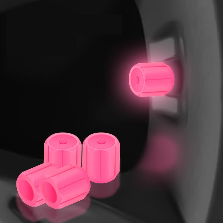 Pink luminous car tire valve caps set, glowing at the wheel valve stem