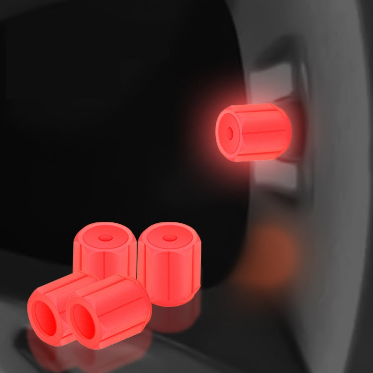 Red luminous car tire valve caps set, glowing at the wheel valve stem