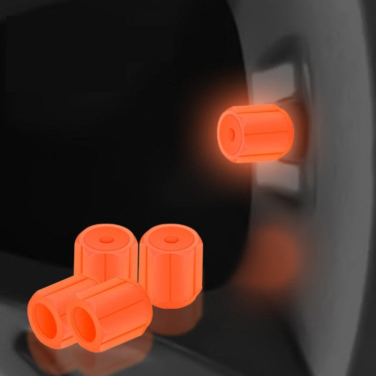 Orange luminous car tire valve caps set, glowing at the wheel valve stem