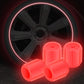 Luminous tire valve caps, red glow, multiple caps near car wheel