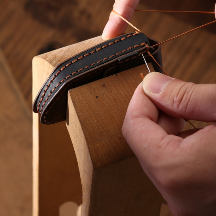 Hand-stitched leather edge of a motorcycle smart remote key case