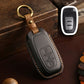 Gray leather key fob holder with brass ring and embossed control icons