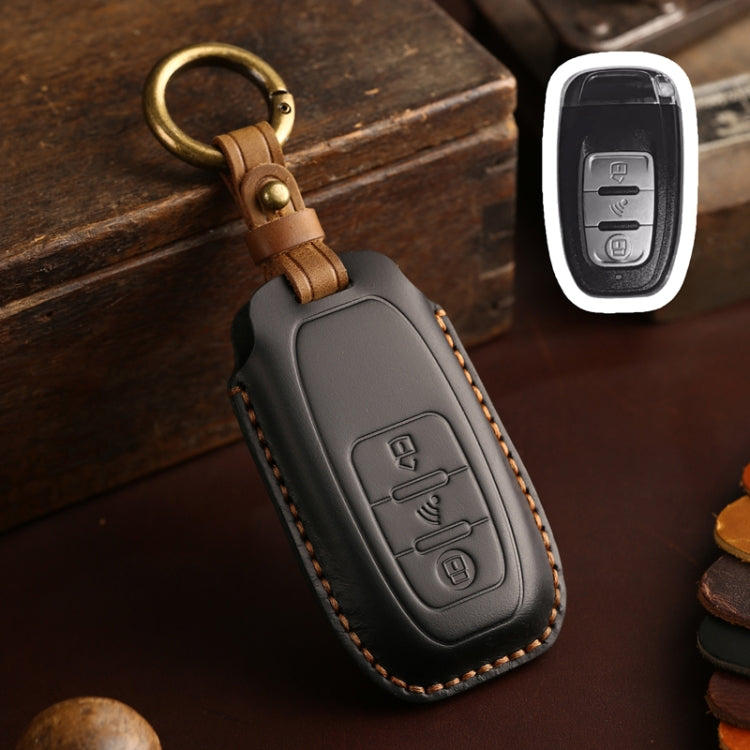 Gray leather key fob holder with brass ring and embossed control icons