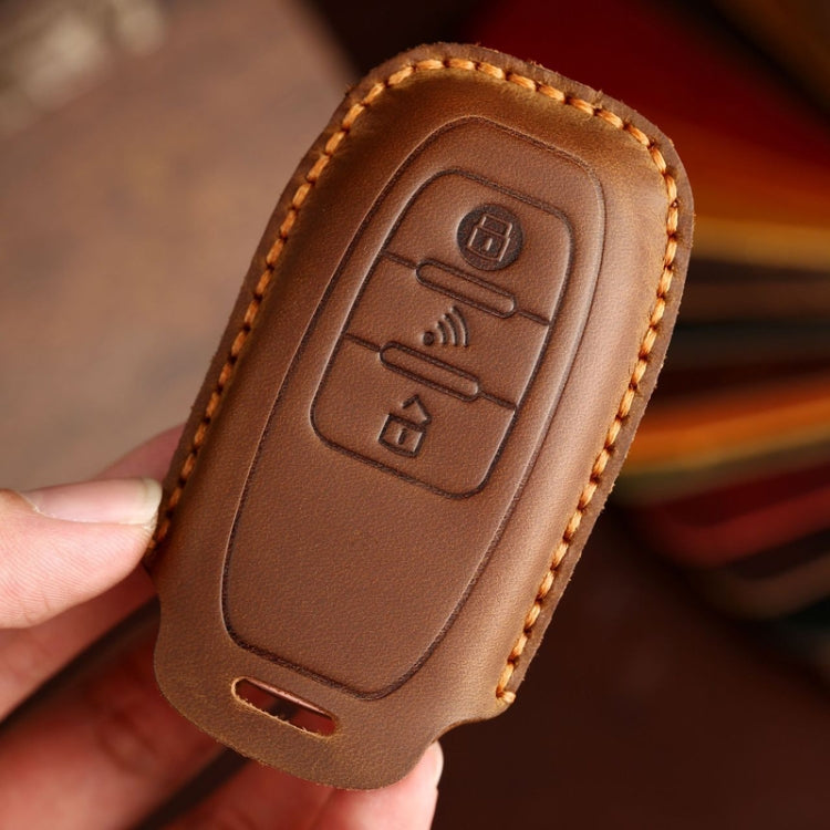 Brown leather key fob cover with embossed remote icons and side opening