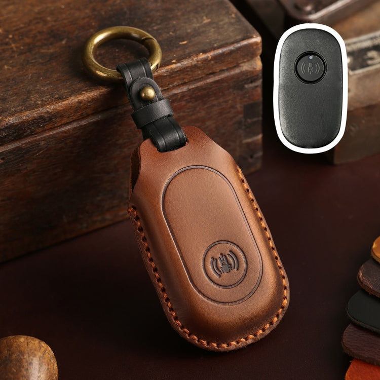 Brown leather remote key protective case with key ring loop and button icon panel.