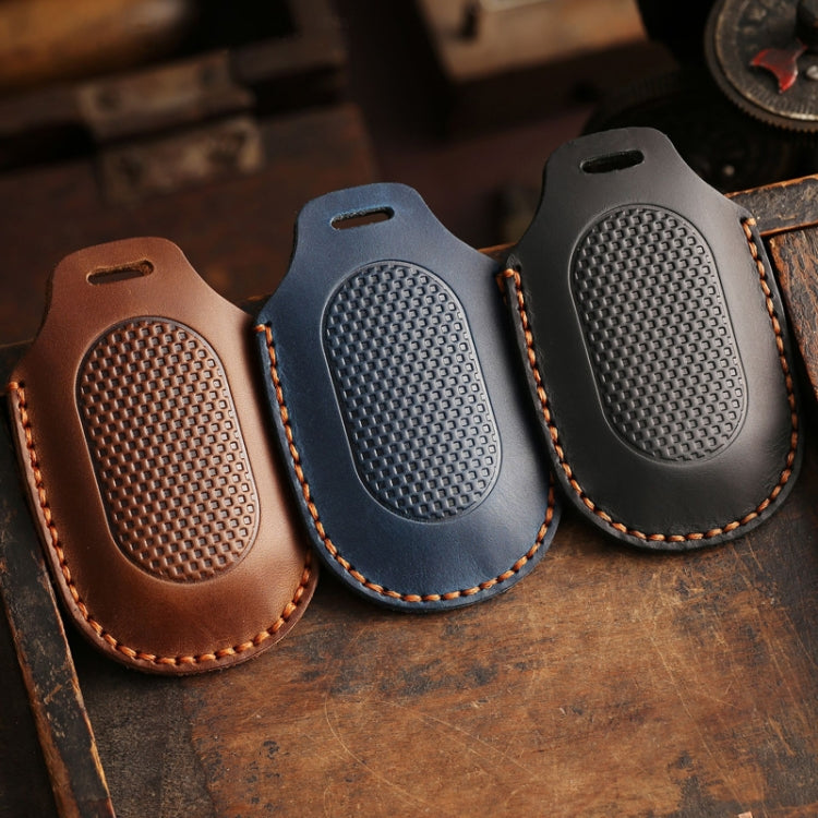 Leather remote key protective cases in brown, blue, and black with textured button covers.