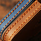 Leather remote key protective case close-up of orange top-stitching and trim edges.