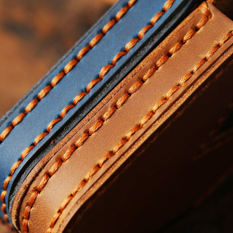 Leather remote key protective case close-up of orange top-stitching and trim edges.