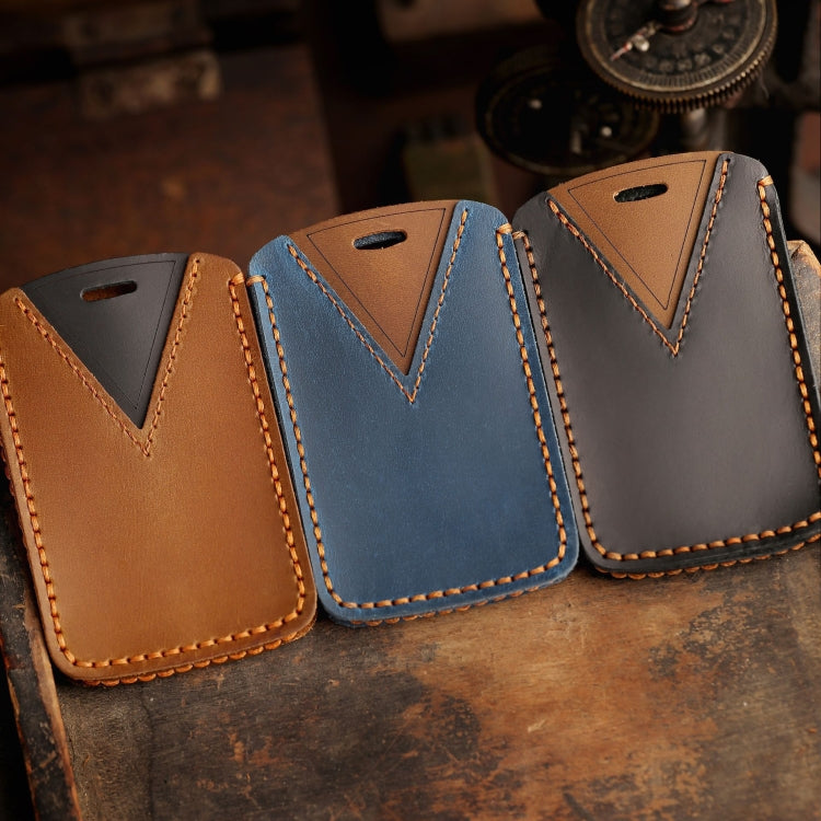 Set of three leather car key cases in tan, blue, and charcoal with V-stitch trim