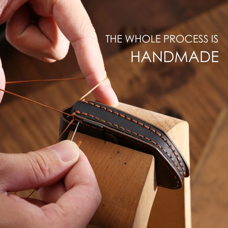 Handmade leather key case with edge stitching being sewn by hand