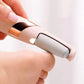 Handheld electric foot grinder with beige handle and black sanding roller