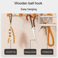 Black wall shelf with wooden ball hooks for keys, scissors, and lanyard