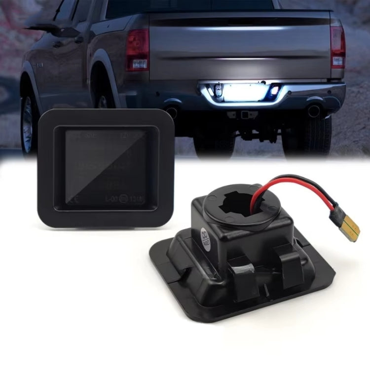 Two black LED license plate light housings with red/black wires and connector