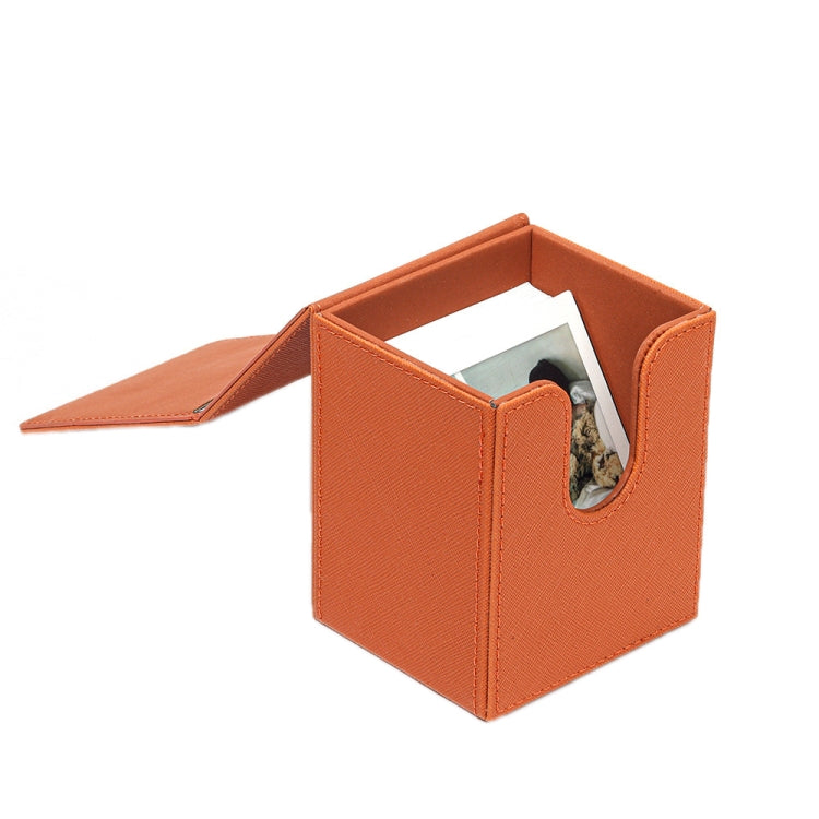 Orange photo storage box opened with top flap and cutout photo window
