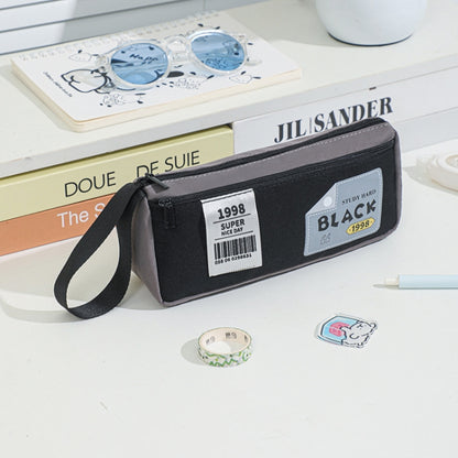 Black double-layer pencil case with wrist strap and printed patch label.