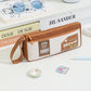 Brown double-layer pencil case with wrist strap and front badge patch.